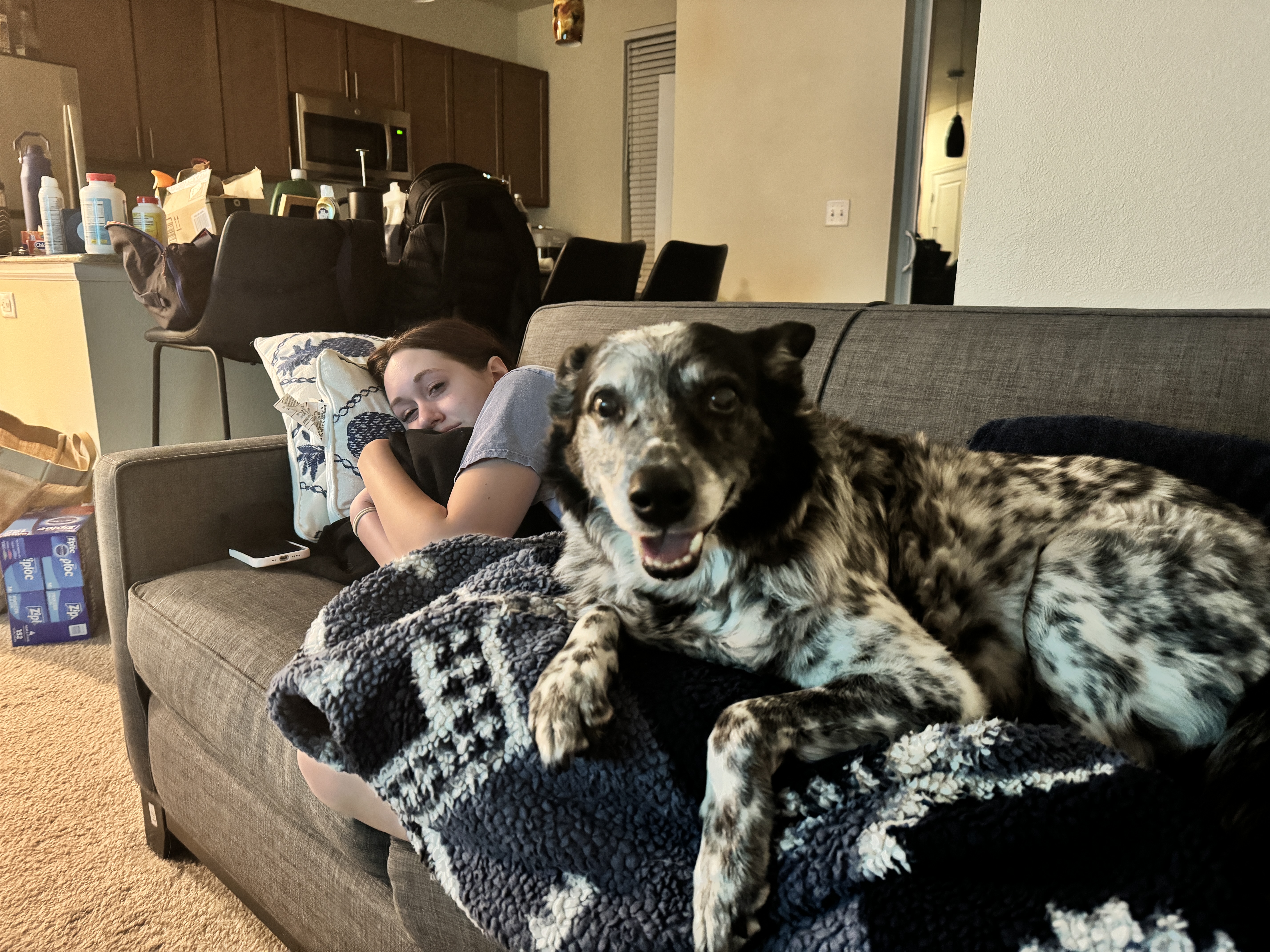 Banzai smiling on the couch beside the daughter he loved.
