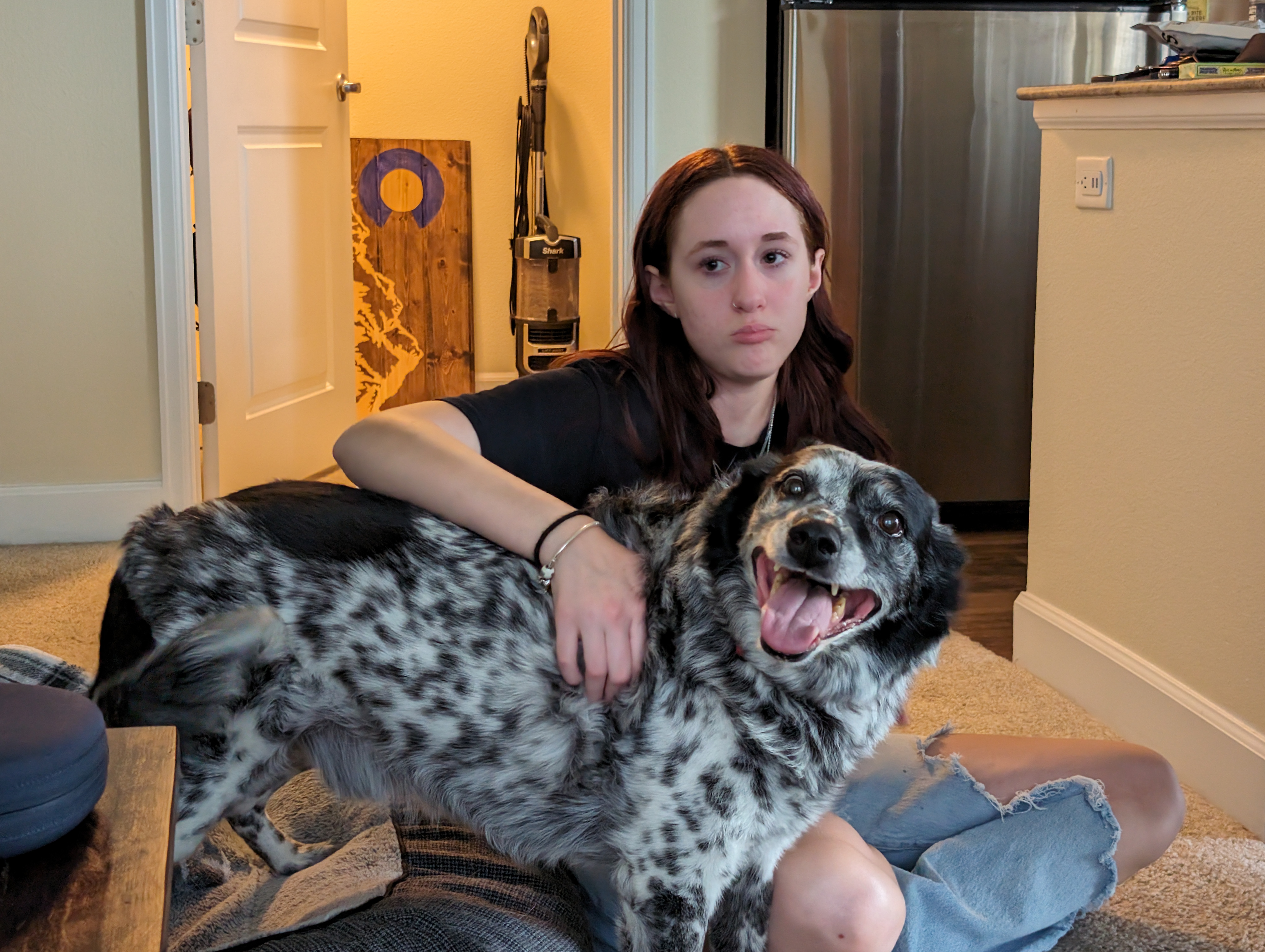 Banzai smiling while being hugged by his family.